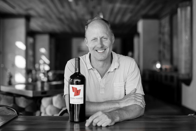 Thomas Rivers Brown, Schrader and Double Diamond winemaker, next to a bottle of Double Diamond