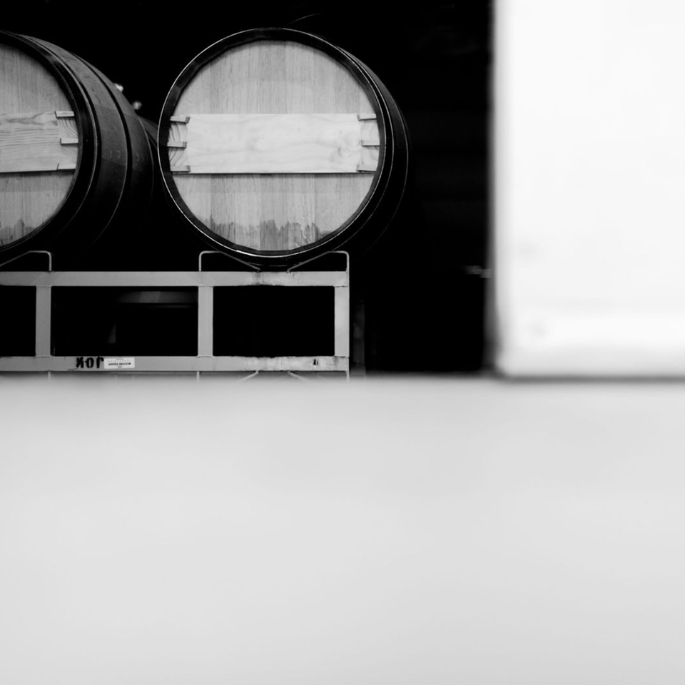 Image of Double Diamond Cabernet Sauvignon wine barrels at a winemaking facility